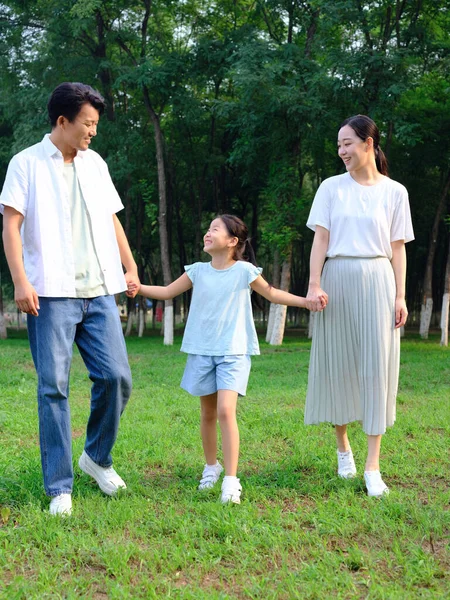 Famiglia felice di tre persone che giocano nel parco — Foto Stock