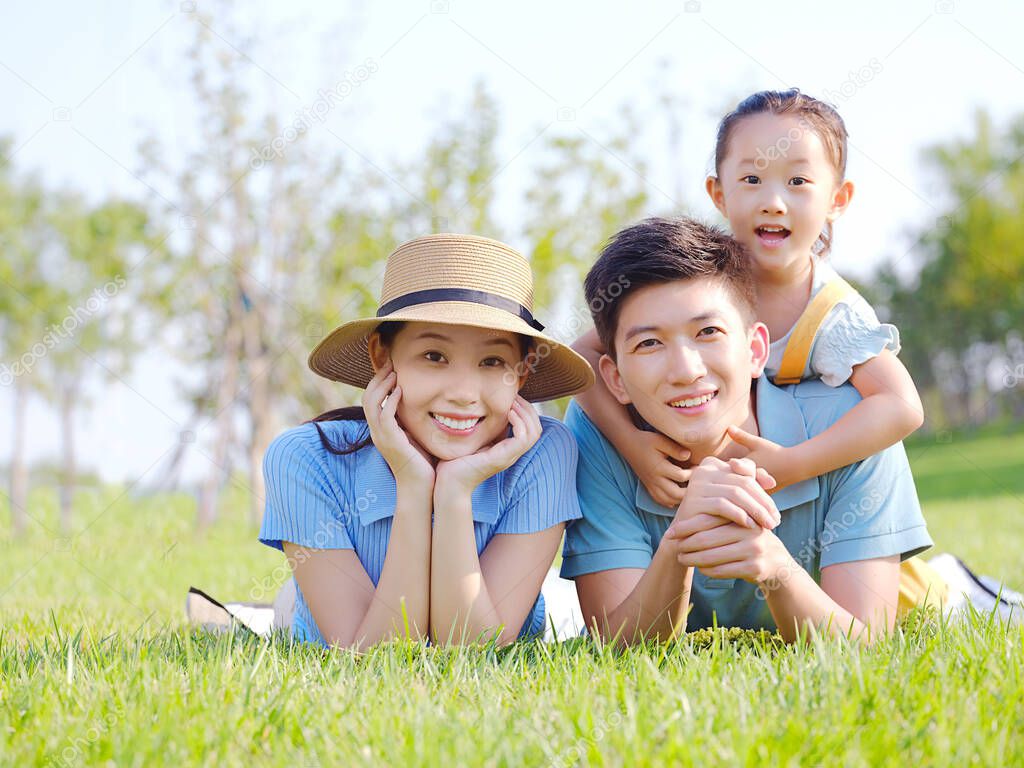 Happy family of three on the grass