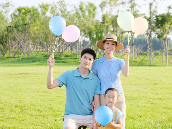 Happy family of three in the park — Stock Photo, Image