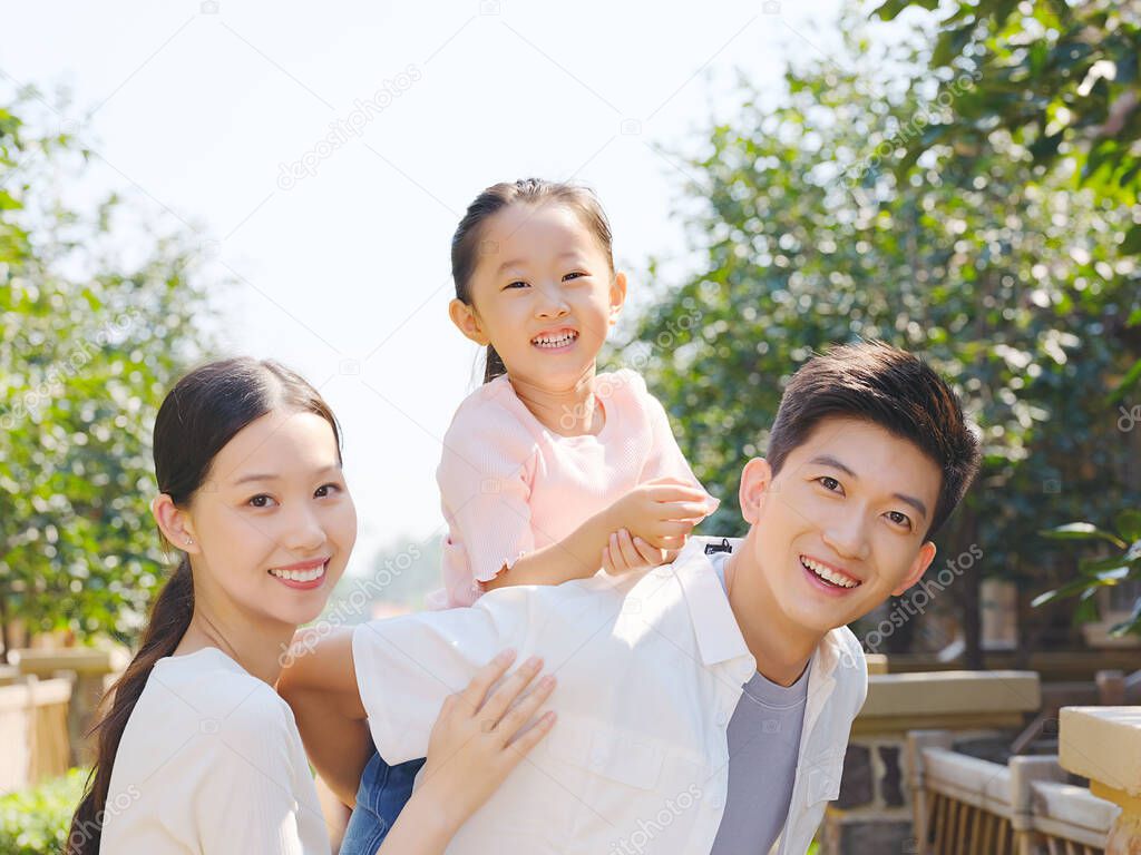 Happy family of three in the outdoor group photo