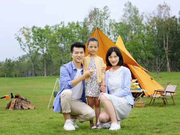 A Happy family of three camping outdoors — Stock fotografie