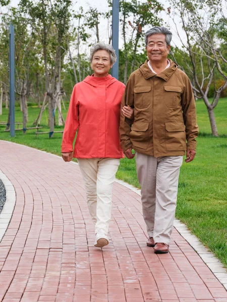 Happy old couple walking in the park — Stock Photo, Image