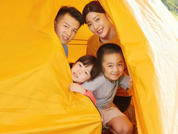 A Happy family of four in tent — Stock Photo, Image