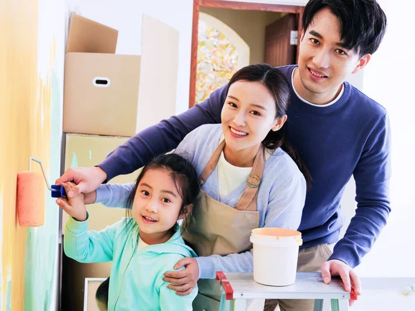 Uma família feliz de três paredes de pintura — Fotografia de Stock