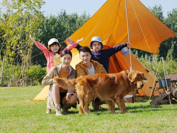 快乐的四口之家和公园里的宠物狗 — 图库照片