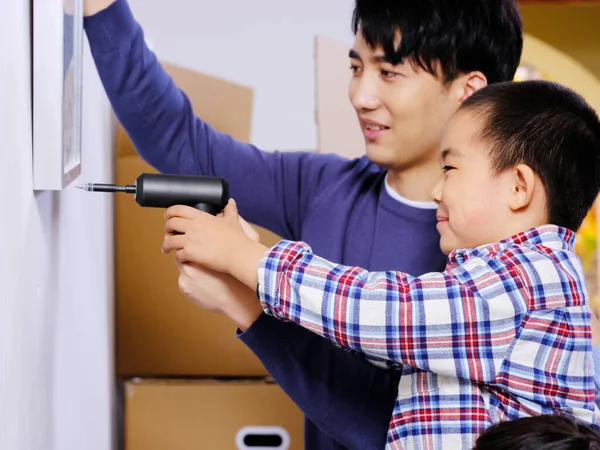 Pai e filho felizes decorar a casa juntos — Fotografia de Stock
