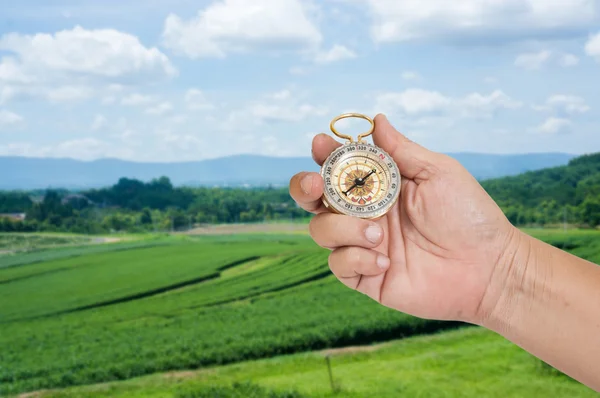 Man holding compass in hand — Stock Photo, Image