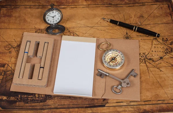 Compass with note book on old map vintage process style — Stock Photo, Image