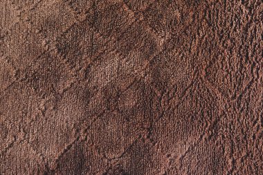 Arka plandaki kahverengi yün kumaşı kapat.