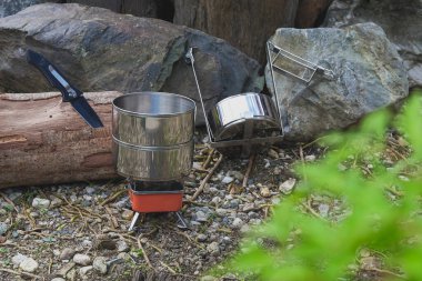 Dağ gününde küçük bir sobayla yemek pişirmek için kullanılan kamp çanağının adı..