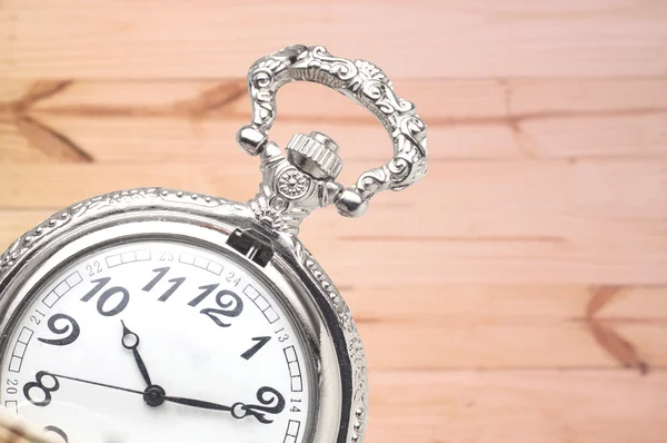 Pocket clock on wood — Stock Photo, Image