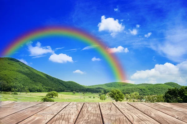 Wood walk with rainbow behind hill — Stock Photo, Image