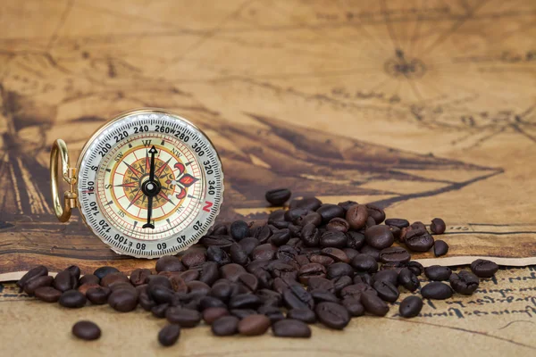 Vintage compass and bean lies on an ancient map — Stock Photo, Image