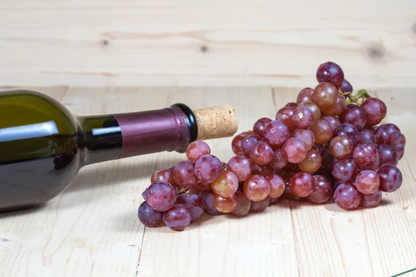 Bottle of  wine and grape  on wooden table — Stock Photo, Image