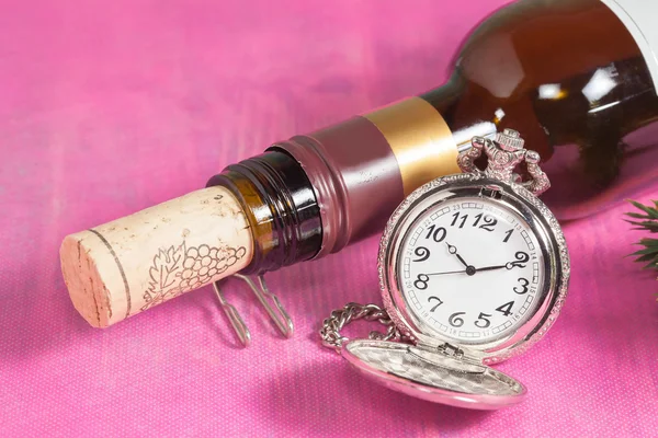 Pocket clock and wine bottle