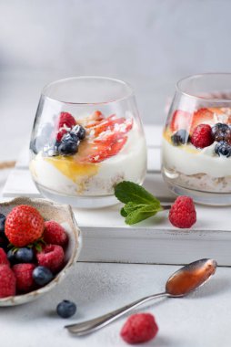 Yoğurt çileği ve reçelli bir bardak tatlı.