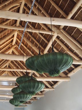 Modern design wooden ceiling. Green chandeliers in the shape of  clipart