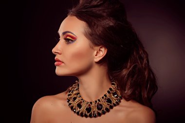 Kahverengi gözlü kadın moda portre. Altın takı. Turuncu öldürülecek