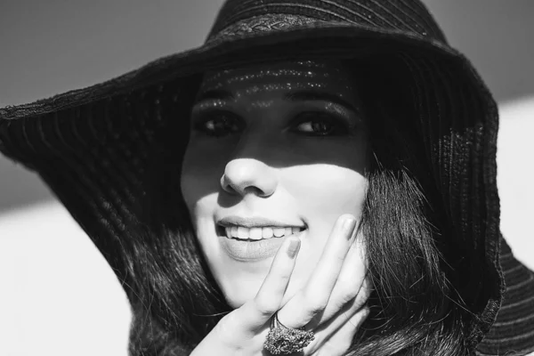 Mujer sonriente con sombrero de rafia negro. Joyería calado oro . — Foto de Stock