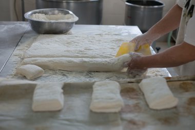 Baker Cutting Raw Ciabatta Bread Dough
