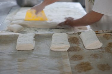 Freshly Made Ciabatta Bread Cut by Baker
