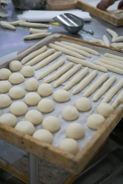 Freshly Made dough for Rolls and Baguettes on Wooden Trays — Stok fotoğraf