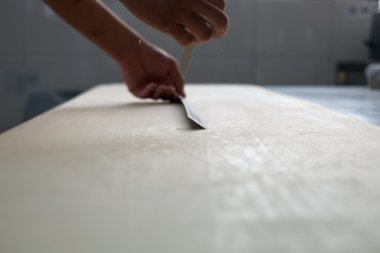 Baker Cutting Croissant Dough