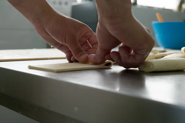 A Baker Rolling Chocolate Pastries — Stock Photo, Image