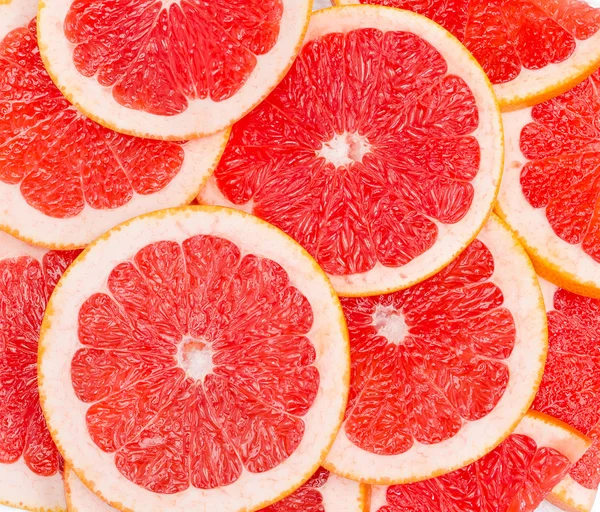 Roter Hintergrund von Grapefruitscheiben — Stockfoto