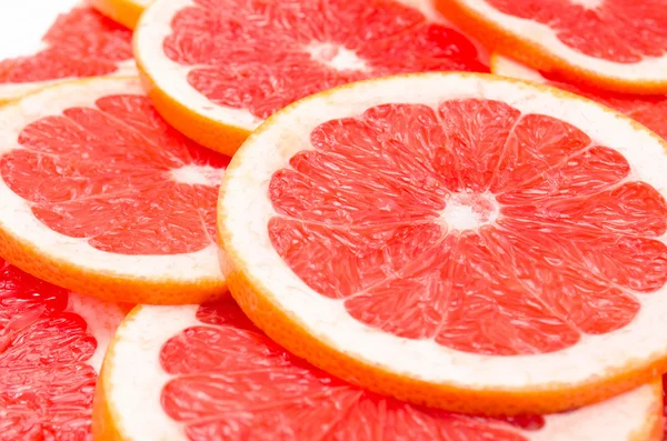 Roter Hintergrund von Grapefruitscheiben — Stockfoto