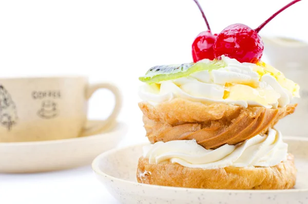Choux pastry with fruit with a cup of coffee.