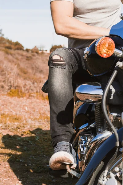 Özel motosiklet kullanan genç motorcunun dikey kısmi görüntüsü