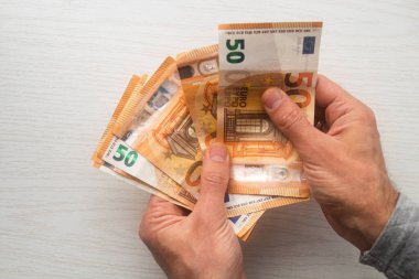 Adam avroyu sayıyor nakit para beyaz masada banknotlar