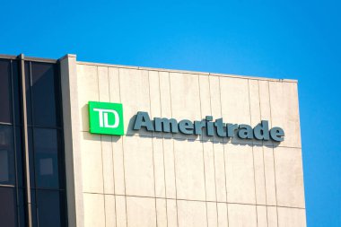 TD Ameritrade sign logo on building facade. TD Ameritrade is a broker that offers an electronic trading platform for the trade of financial assets - Los Angeles, California, USA - 2020 clipart
