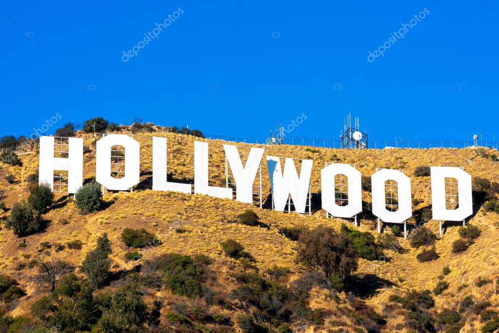 Hollywood sign white letters under blue sky on Mount Lee. The Hollywood Sign is an American landmark and cultural icon overlooking Hollywood - Los Angeles, California, USA - 2020