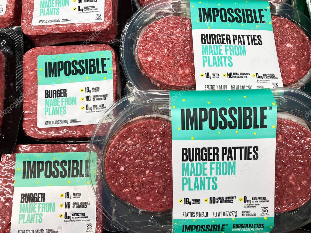 Impossible Foods brand made from plants Impossible Burgers patties in refrigerator section of the meat department of grocery store - San Jose, California, USA - 2021