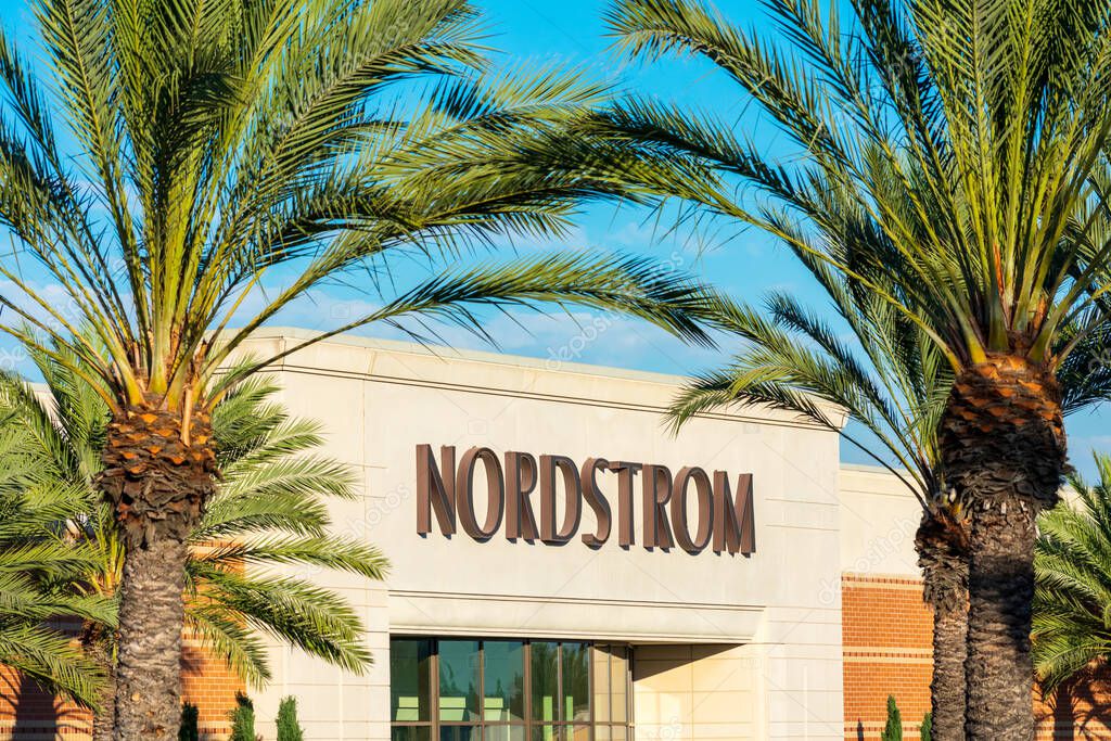 Nordstrom sign above the store entrance behind palm trees. Nordstrom, Inc. is an American luxury department store chain. - Palo Alto, California, USA - 2020