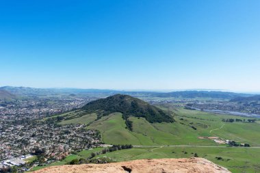 Aerial scenic view from the top of Bishop Peak toward Cerro San Luis Obispo mountain on sunny spring day clipart