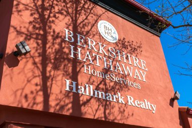 Berkshire Hathaway HomeServices Hallmark Realty sign on the office facade - Paso Robles, California, USA - 2021 clipart