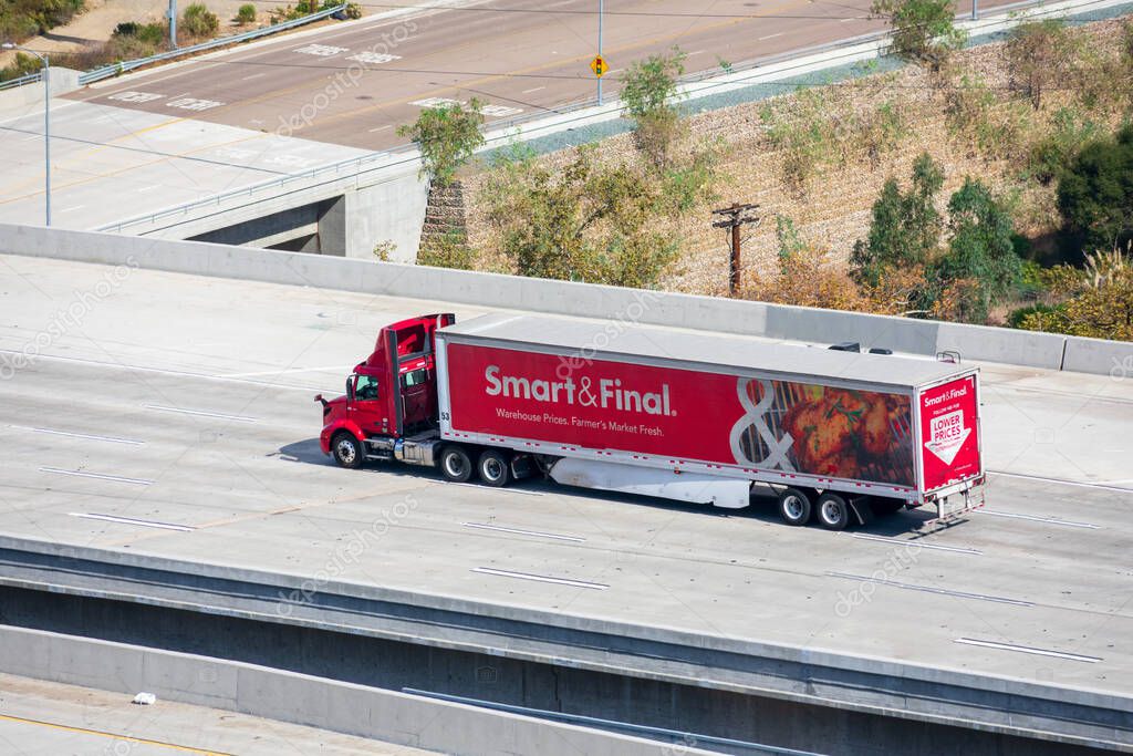Aerial view of Smart and Final grocery store delivery truck driving on highway. - San Diego, California, USA - 2020