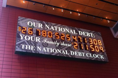 National Debt Clock a billboard sized running total display shows the current United States gross national debt and each American family's share of the debt - New York, USA - June 3, 2021 clipart