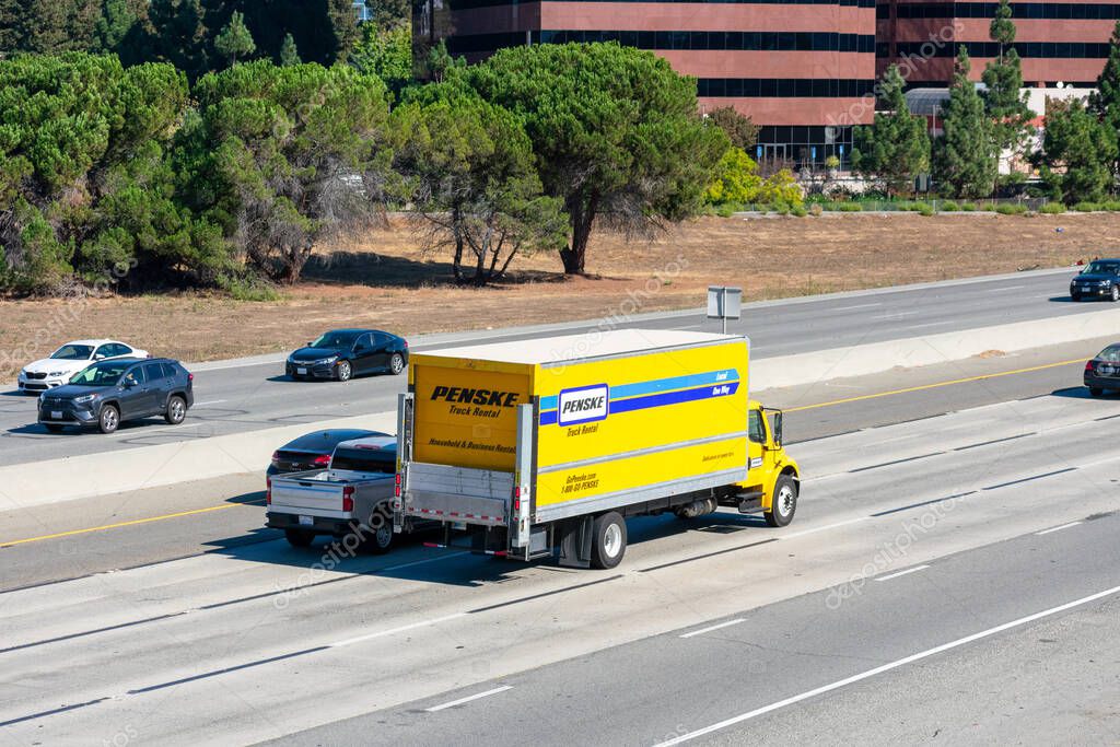 Penske rental truck is driving on a multilane highway. Elevated view - San Jose, California, USA - 2020