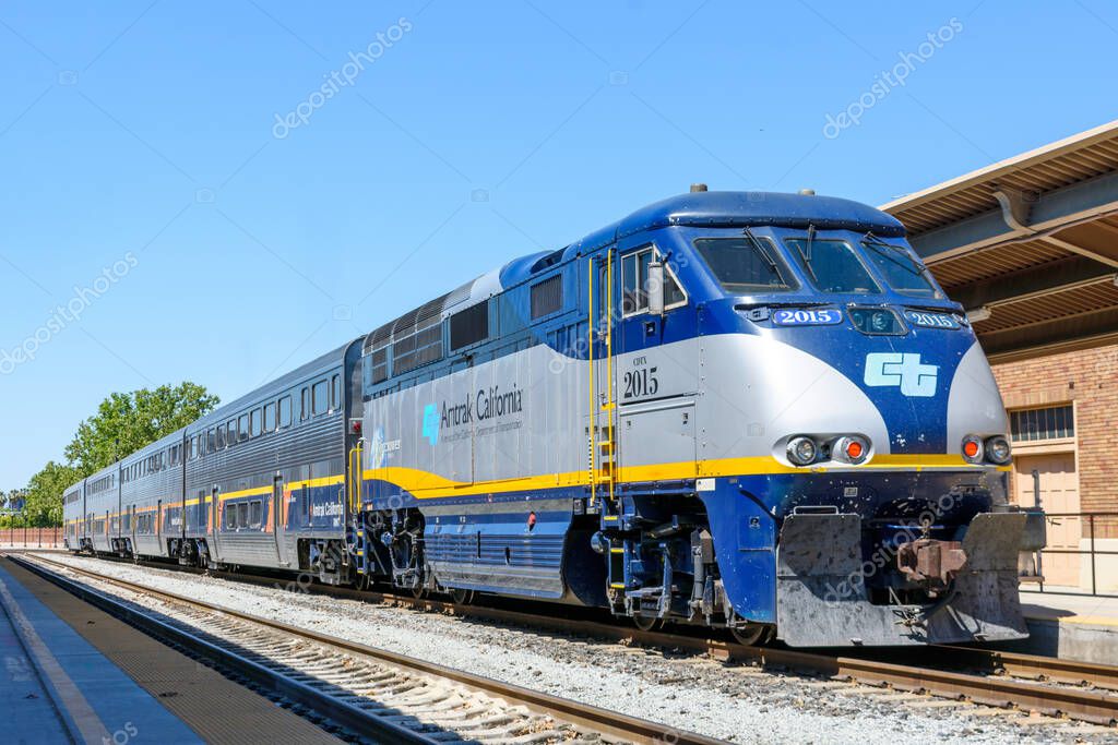 Amtrak California and Caltrans diesel-electric locomotive and passenger coach cars at San Jose Diridon train station. - San Jose, California, USA - 2021