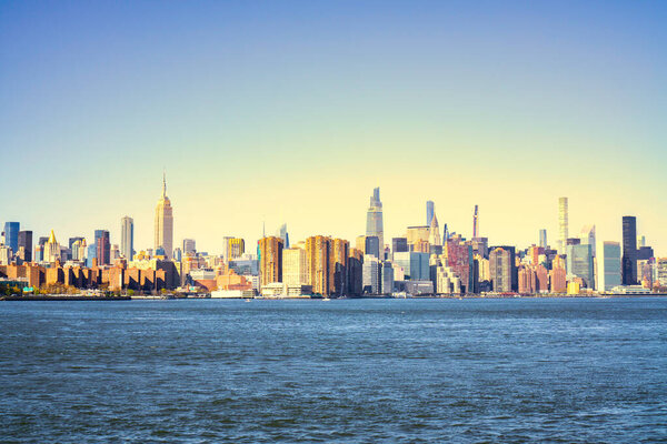 Panorama of New York City skyscrapers in front of water. Skyline of New York City at sunset