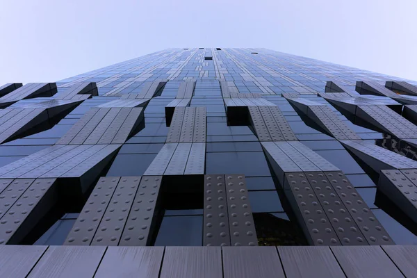 Looking up tall glass and steel high-rise building. Windows of hi-tech building. Abstract modern architecture. Geometric background of frames.