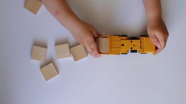 Baby Hands White Background Baby Playing Wooden Cubes Yellow Truck — Stock Video