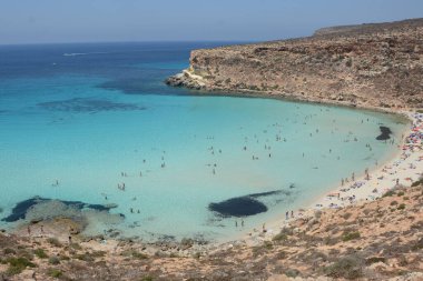 Transparent and blue water in the sea of Lampedusa at the Rabbits beach. The Pelagie Islands are the southernmost point of Italy in Sicily. clipart