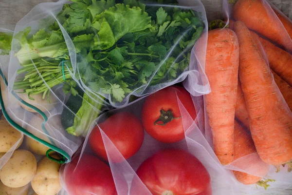 Großaufnahme von Gemüse in wiederverwendbaren Öko-Tüten. Pflanzenzüchtung, Kochen, gesunde Ernährung. Vegetarisches Essen. Bewusster Konsum. — Stockfoto