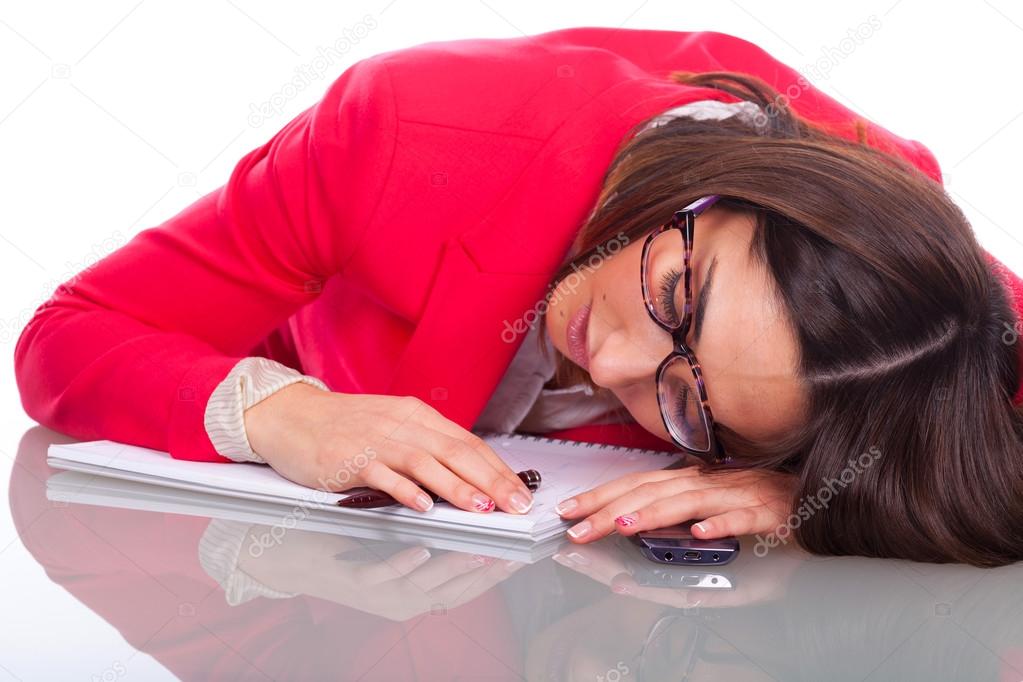 young woman falls asleep on desk