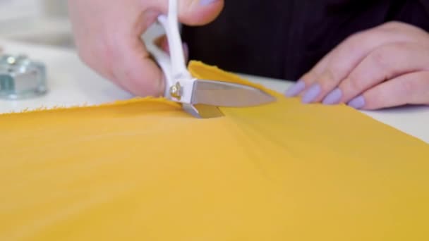 Handen inkeping kleermaker kleermakers schaar doek snijden een stuk stof. modeontwerper concept — Stockvideo